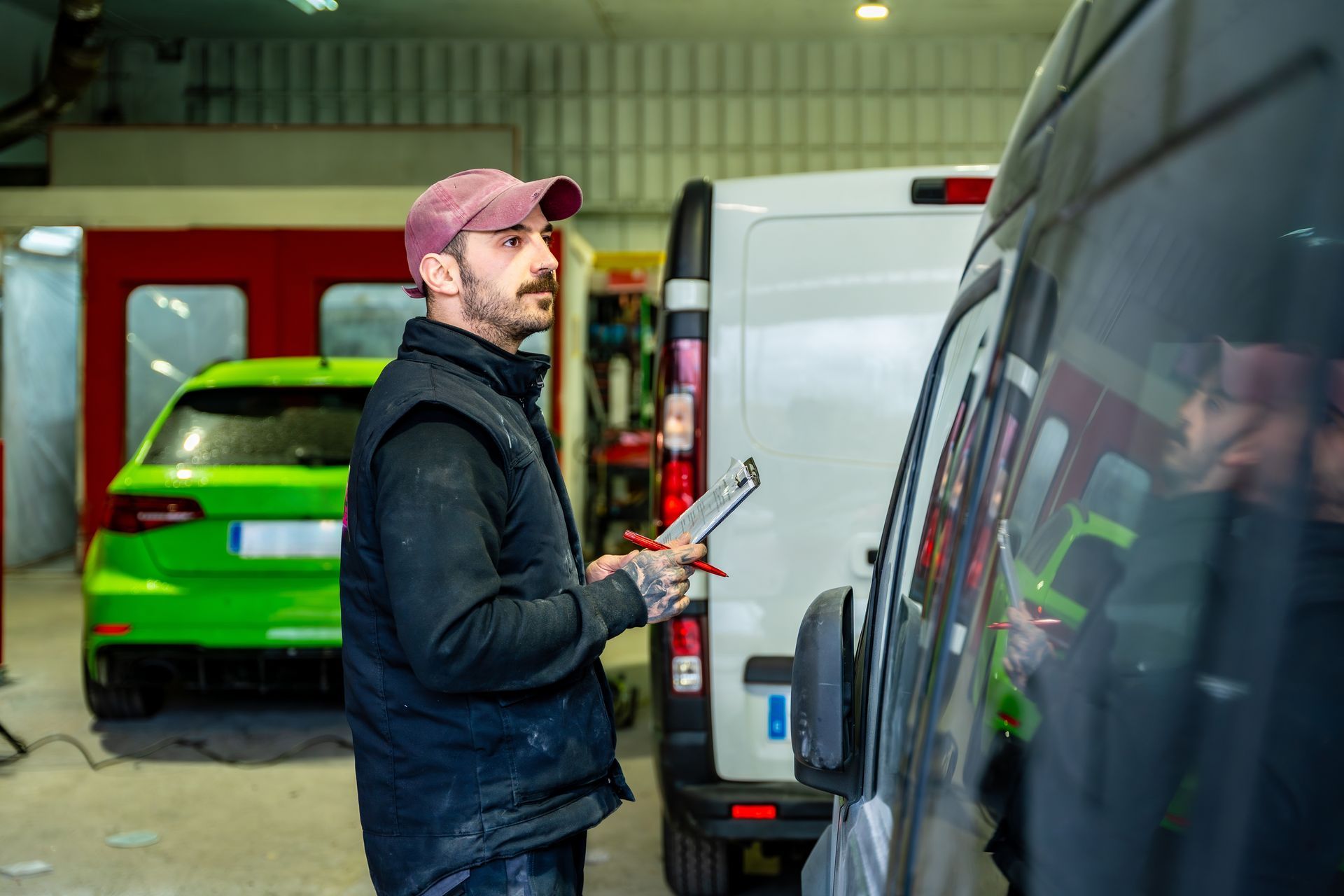 Three commercial vans parked in a row on a paved lot, viewed from the front at a low angle.