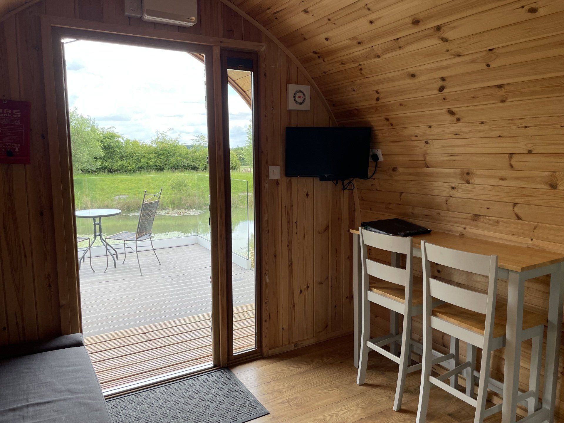 A living room with a couch , table , chairs and a television.
