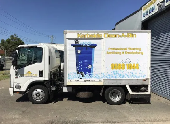 Truck from Kerbside Clean-A-Bin used for professional wheelie bin washing, sanitizing, and deodorizing services parked outside a commercial building.