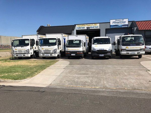 five bin cleaning trucks lined up