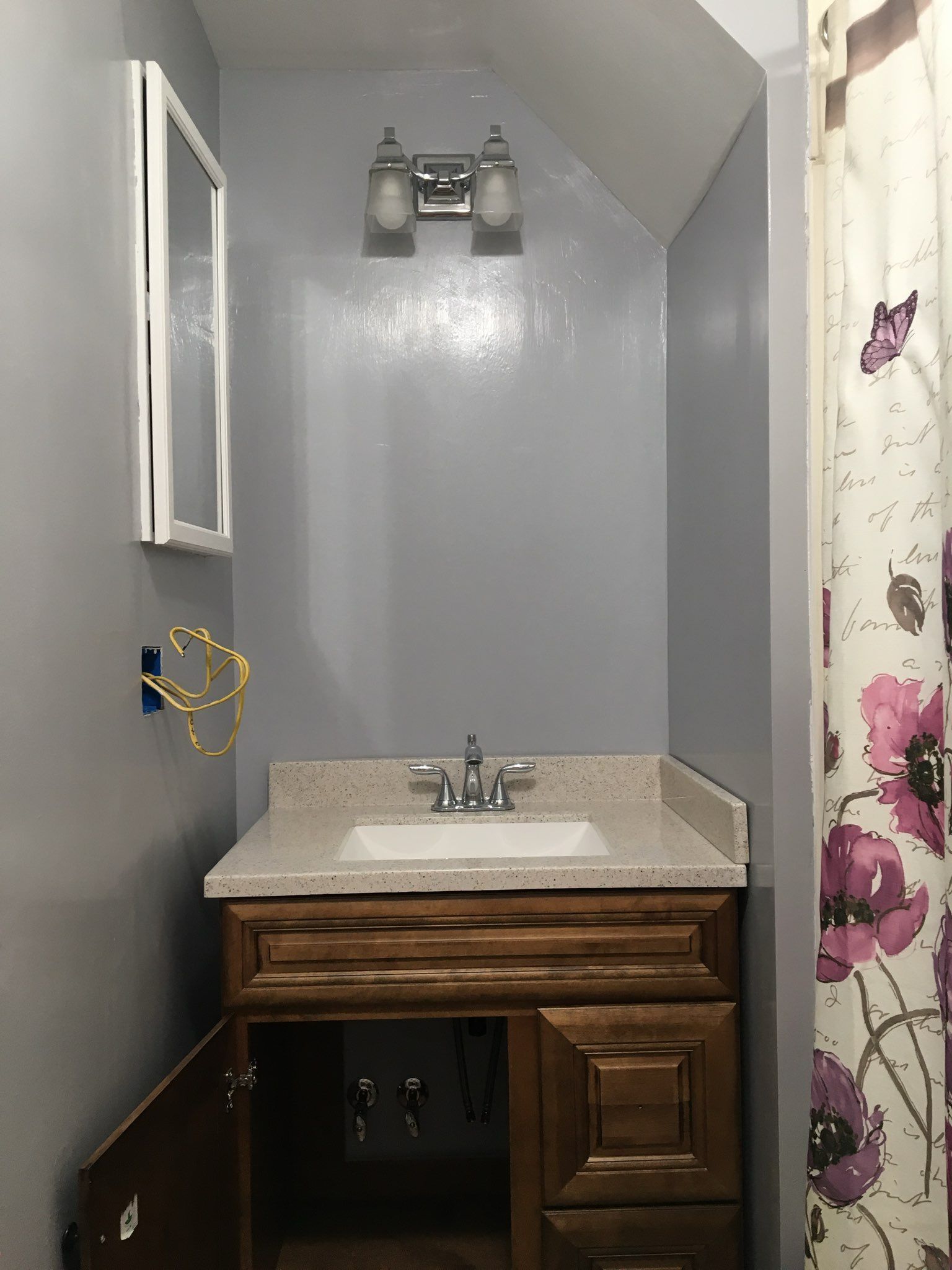 A plumber fixing a toilet; in a bathroom.