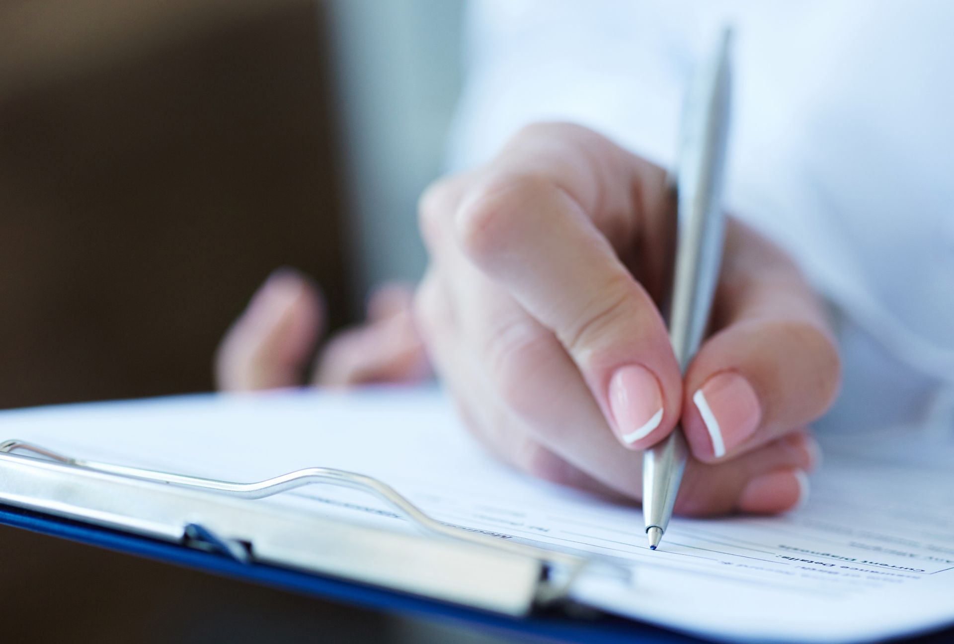 A patient signing a document