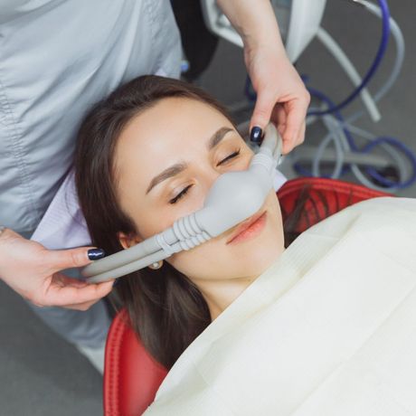 A woman being given anesthesia to sleep