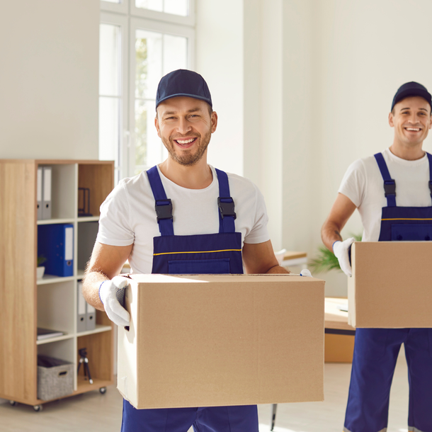 A man and two women are standing next to each other holding cleaning supplies.