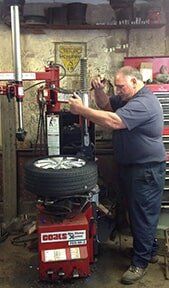 Man in Repairing Tire Shop - Tire Repair in Northampton, MA
