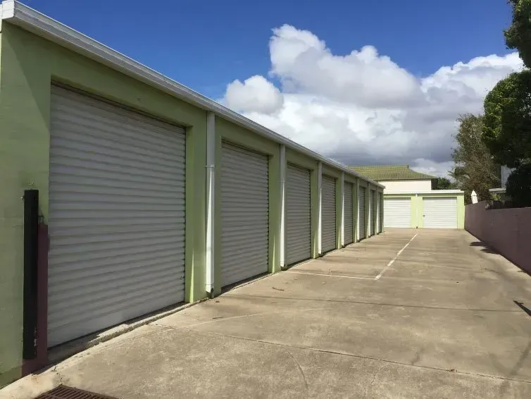 A row of cardboard boxes stacked on top of each other on wooden pallets.
