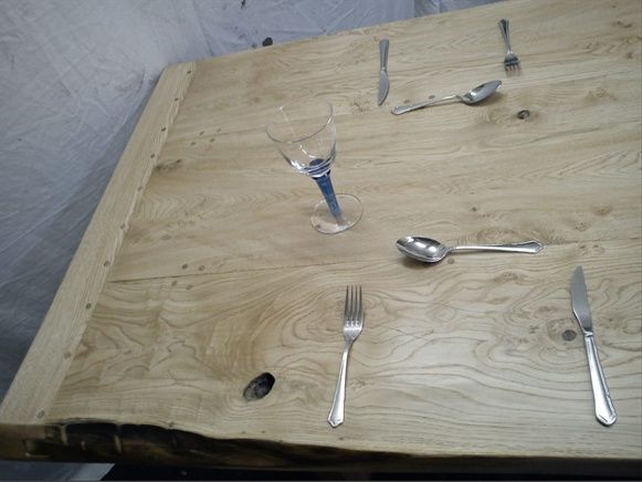 Dining table in Sweet Chestnut, showing planked top in detail laid out cutlery