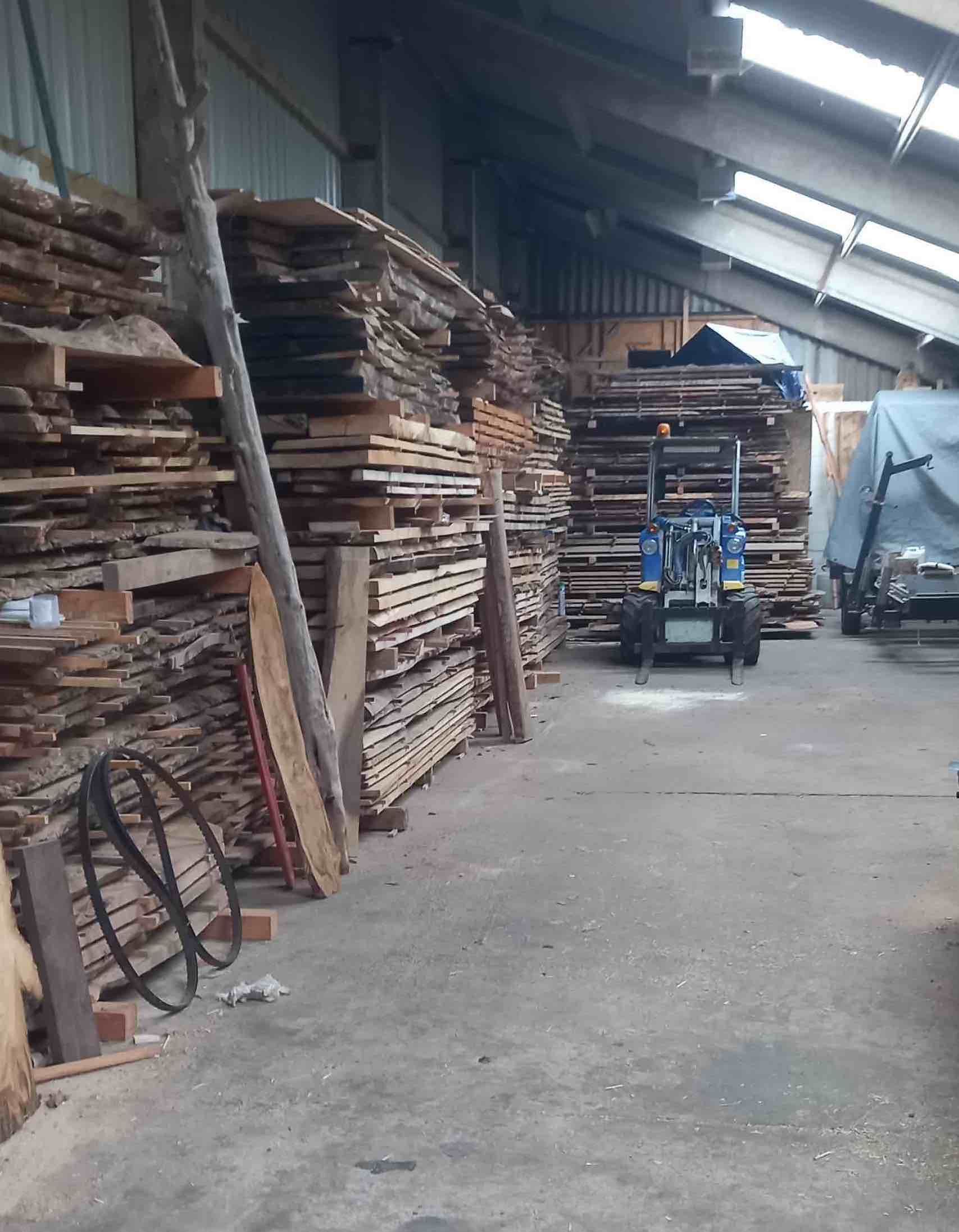 image showing stacks of dry timber in our wood barn