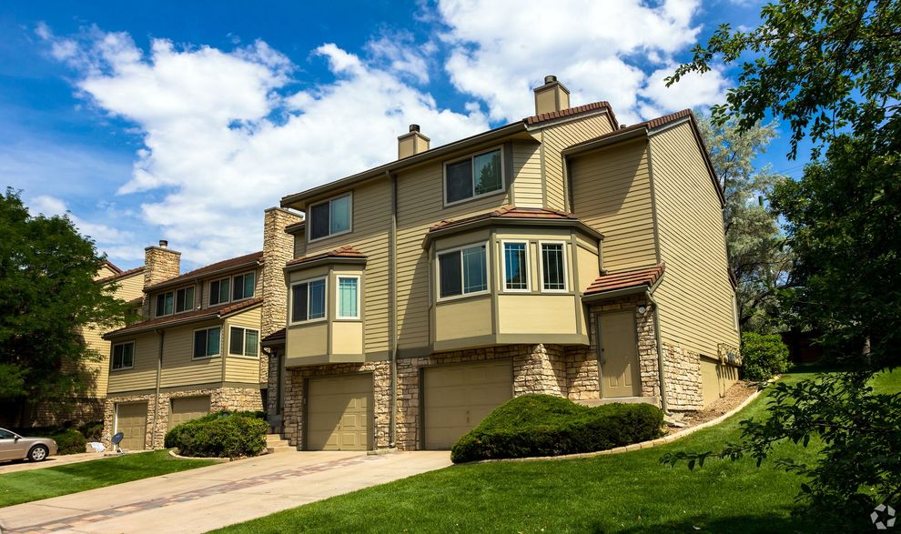 A large house with a lot of windows and a car parked in front of it.