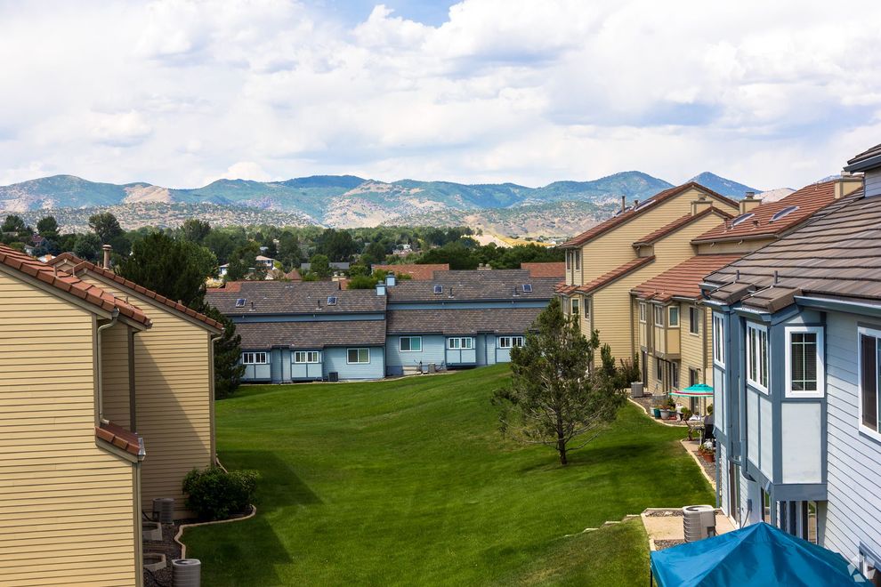 An aerial view of a residential area with mountains in the background