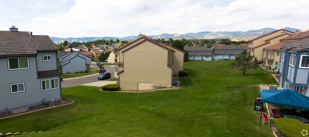 An aerial view of a residential area with houses and a large lawn.