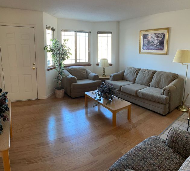 A living room with a couch a chair and a coffee table