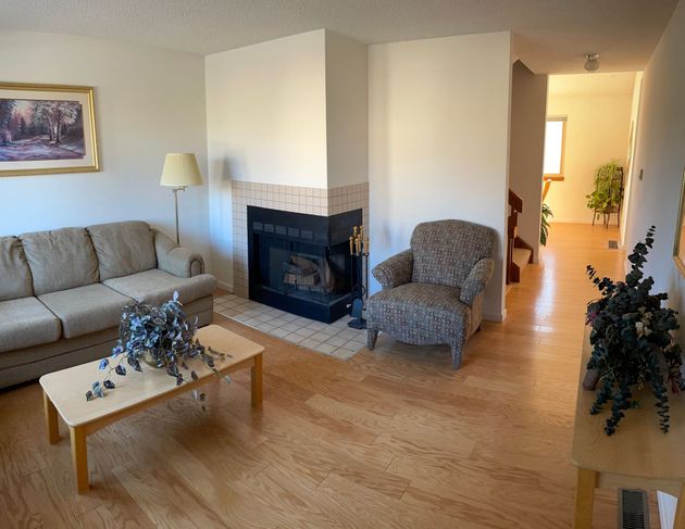 A living room with a fireplace and a couch