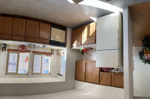 A kitchen with wooden cabinets and a white refrigerator