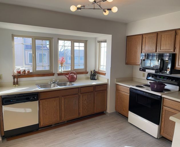 A kitchen with wooden cabinets and stainless steel appliances