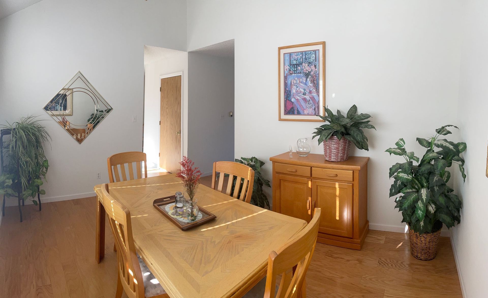A dining room table and chairs are upside down in a room.