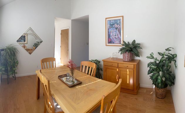 A dining room table and chairs are upside down in a room.