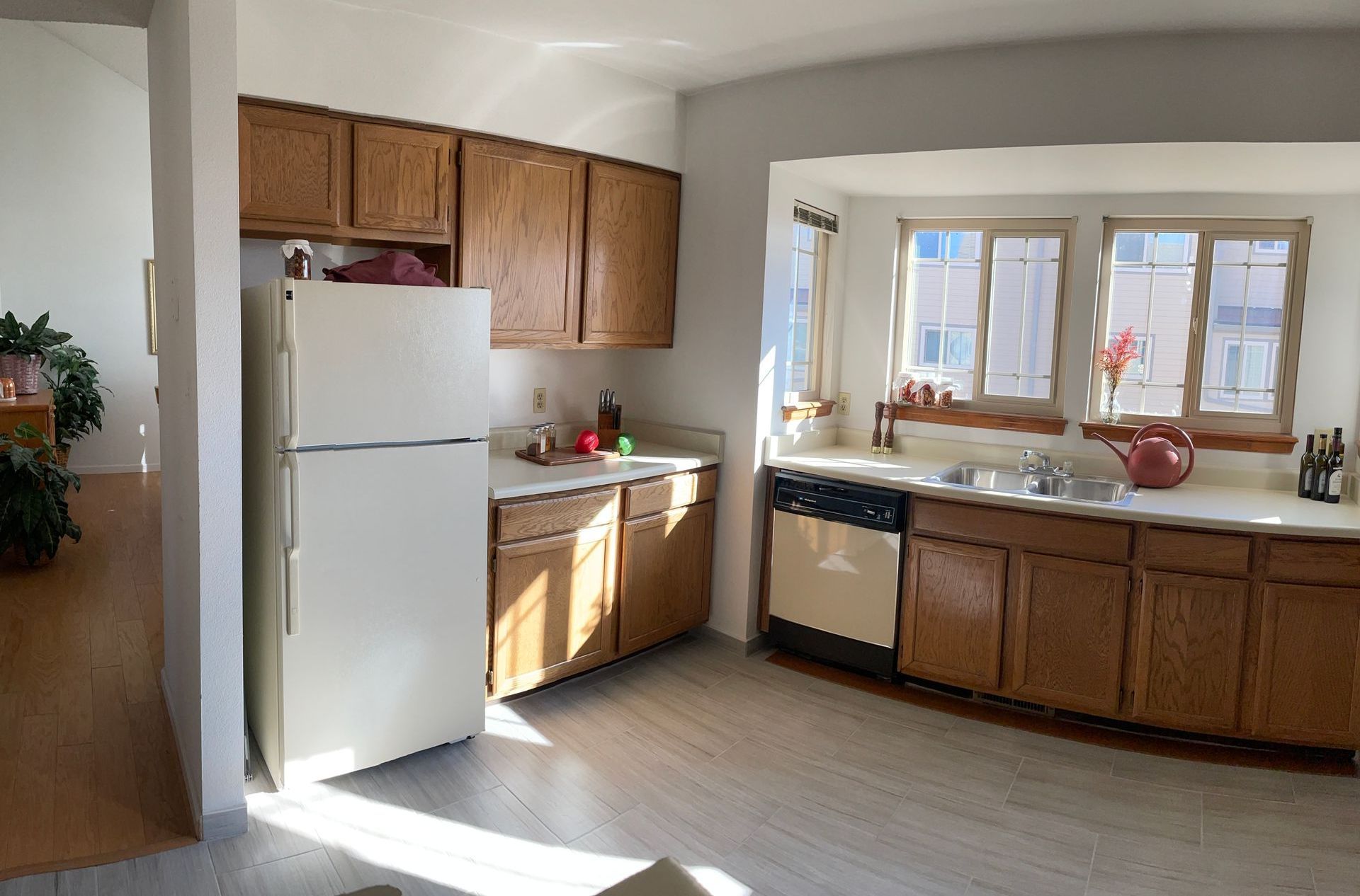 A kitchen with wooden cabinets and a white refrigerator