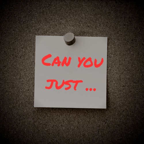 Grainy image of a corkboard. A post it note with the words 