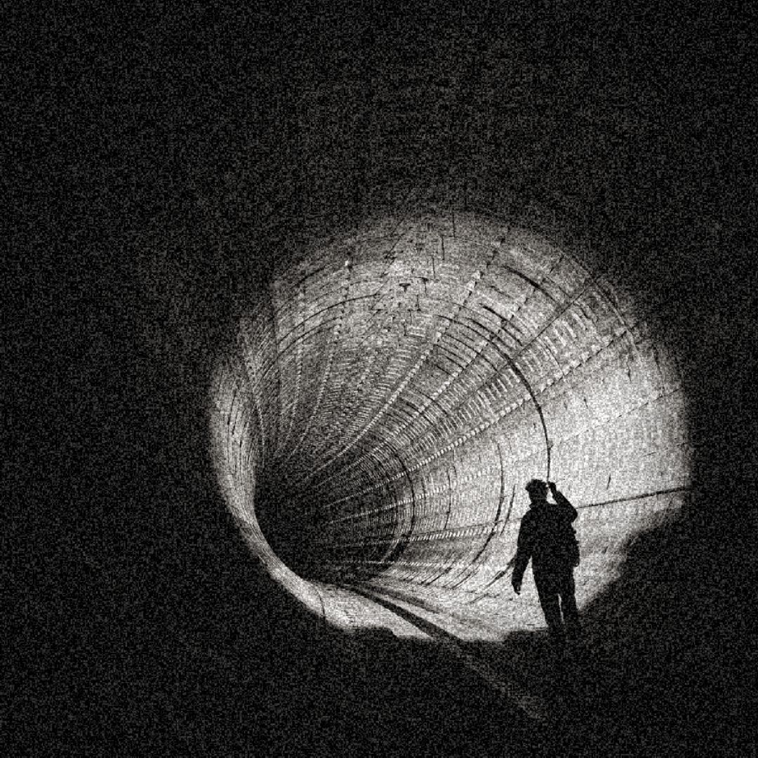 image of a person in a tunnel, with a singular light