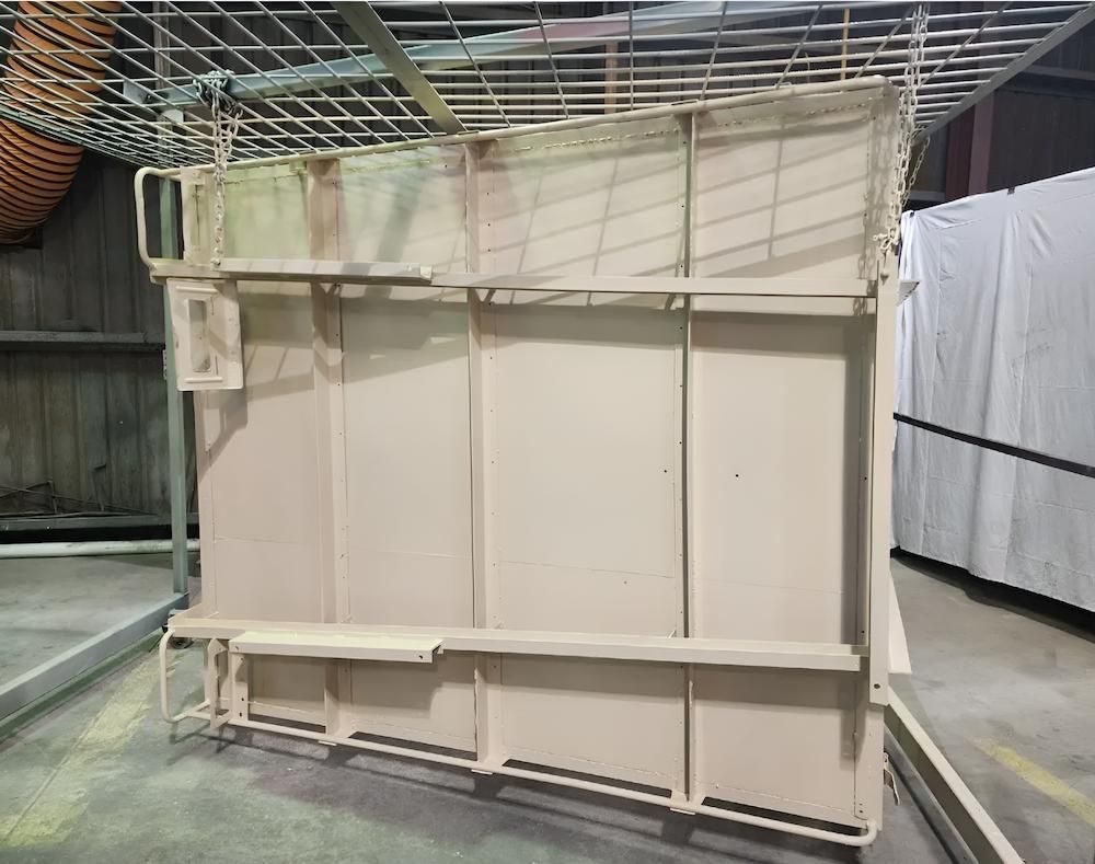 A Large Piece Of Metal Is Sitting On The Ground In A Warehouse — ADK Coatings In Gladstone, QLD