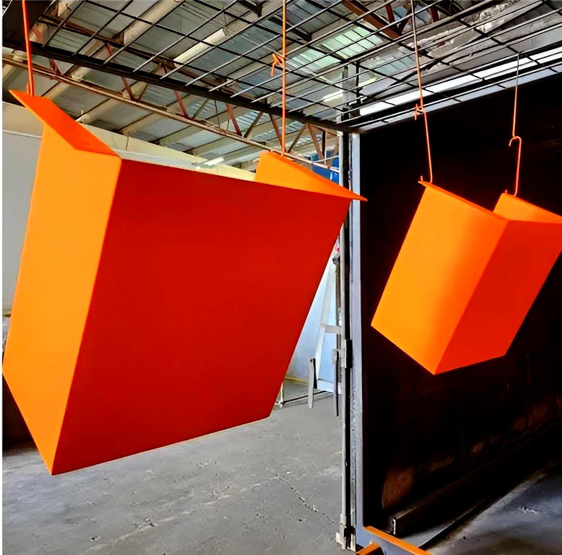 Two Orange Boxes Are Hanging From The Ceiling In A Warehouse — ADK Coatings In Gladstone, QLD