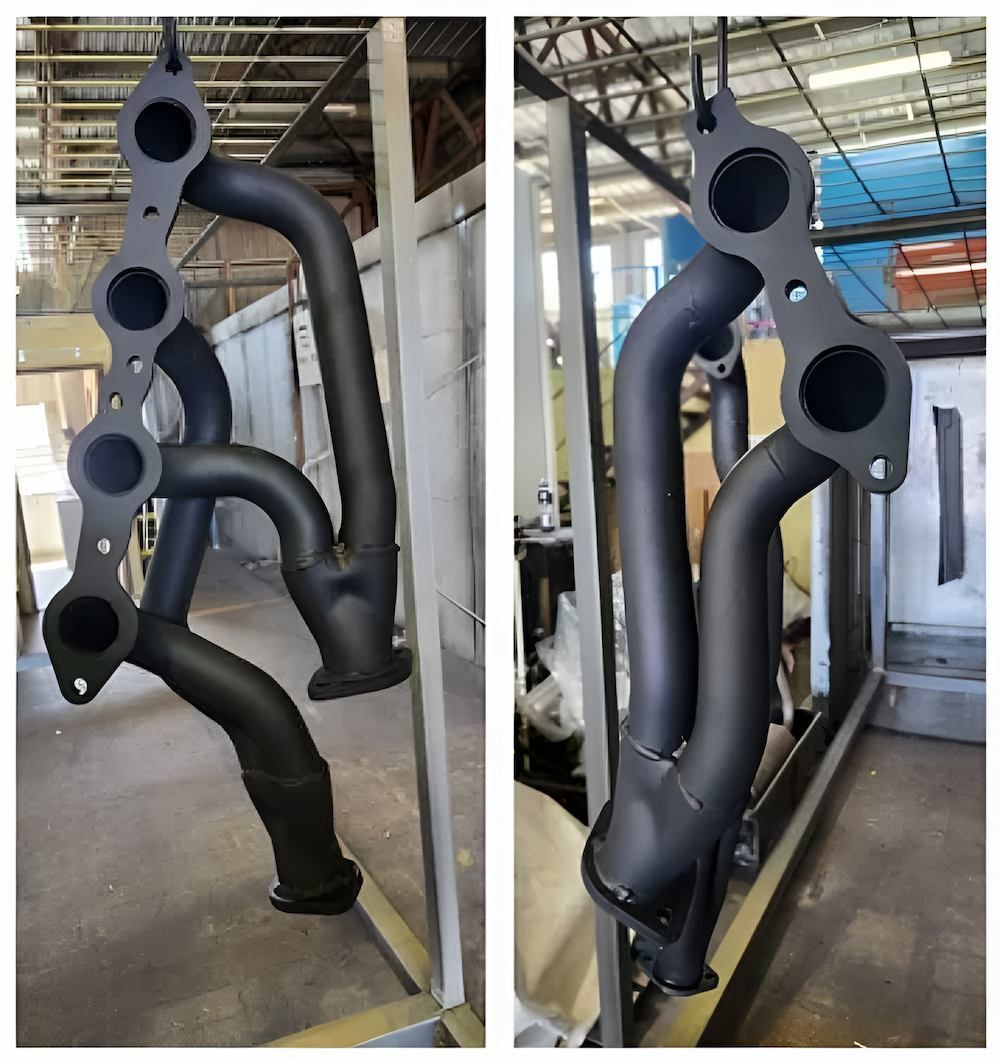 A Pair Of Black Pipes Sitting On Top Of Each Other In A Warehouse — ADK Coatings In Toolooa, QLD