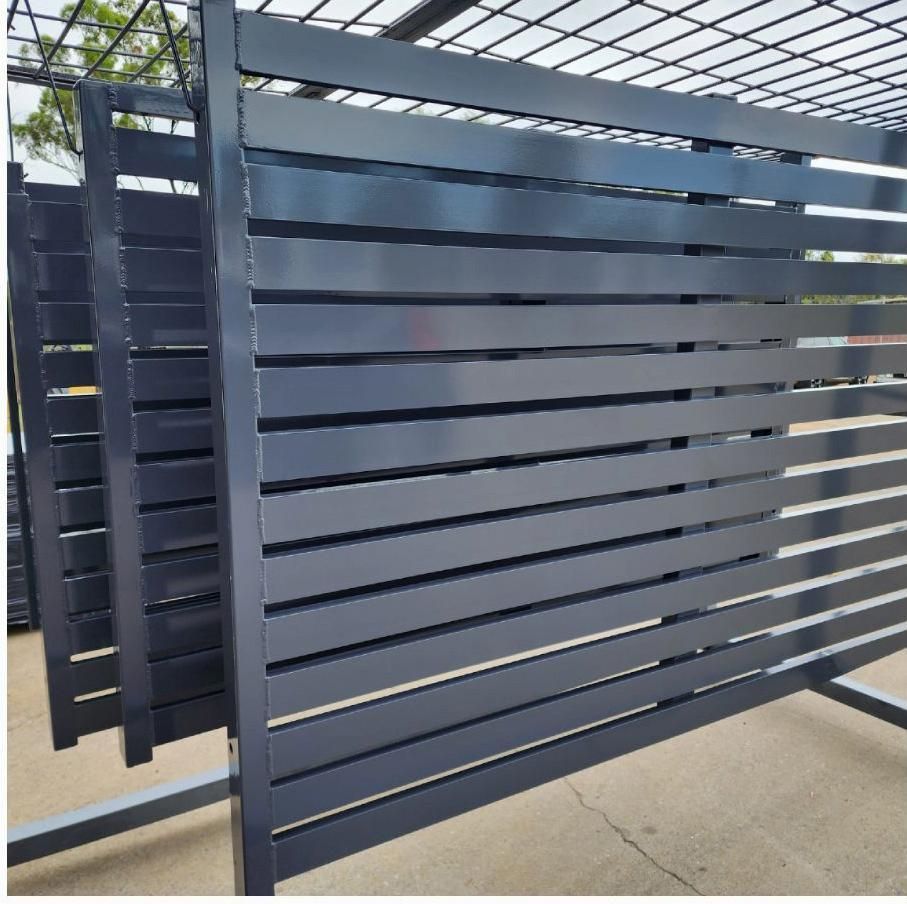 A Black Metal Fence Is Sitting On The Ground — ADK Coatings In Biloela, QLD