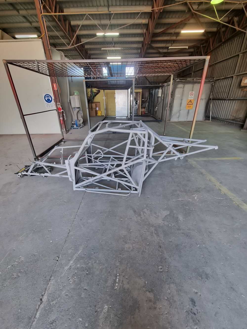 A Large Metal Structure Is Sitting In A Warehouse — ADK Coatings In Toolooa, QLD