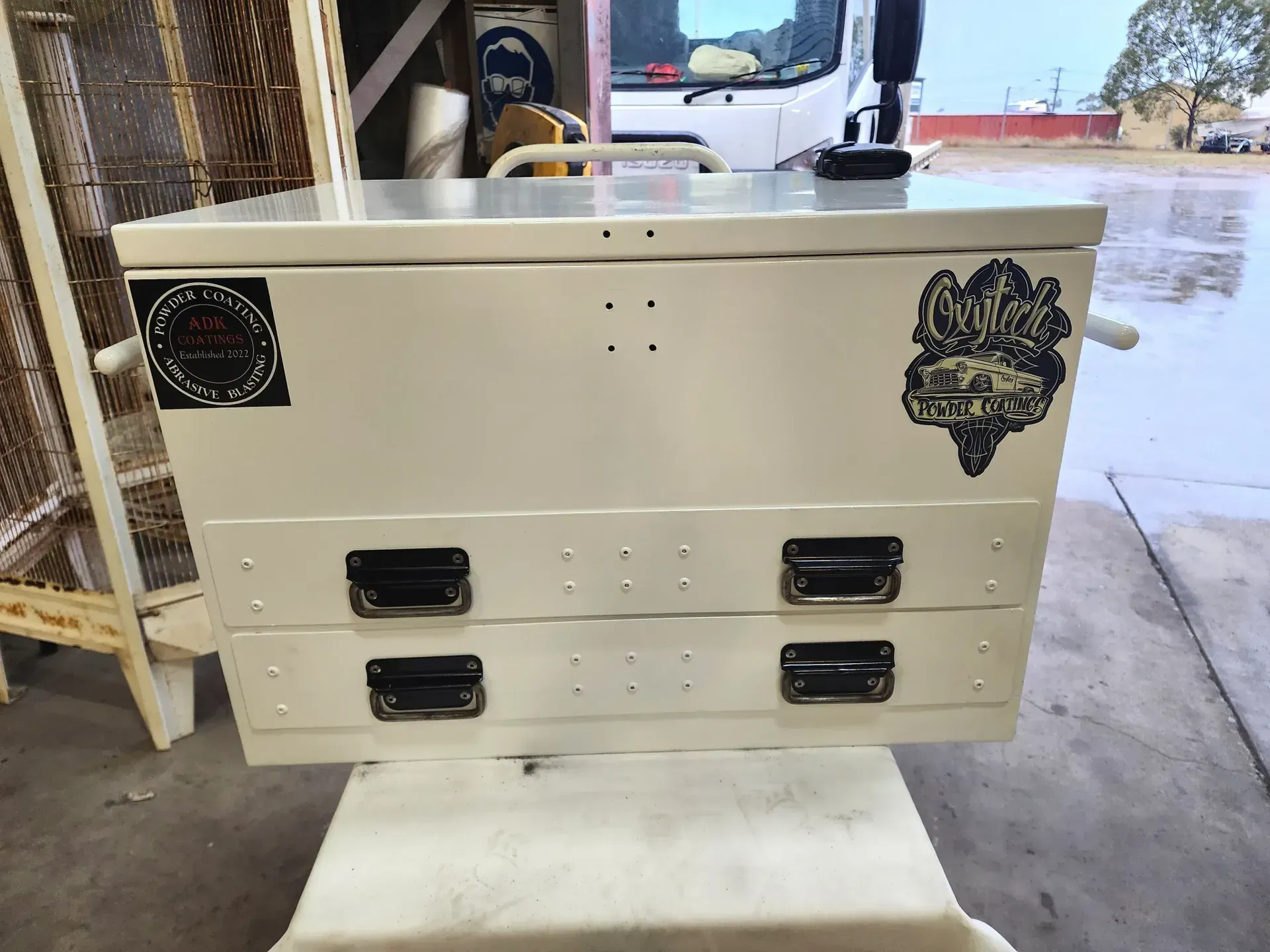 A White Toolbox With Three Drawers Is Sitting On Top Of A White Table — ADK Coatings In Rockhampton, QLD