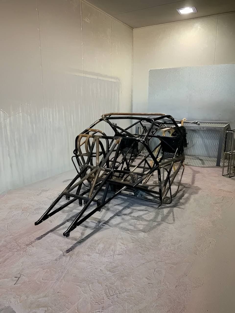 A Metal Frame Of A Car Is Sitting In A Room — ADK Coatings In Rockhampton, QLD