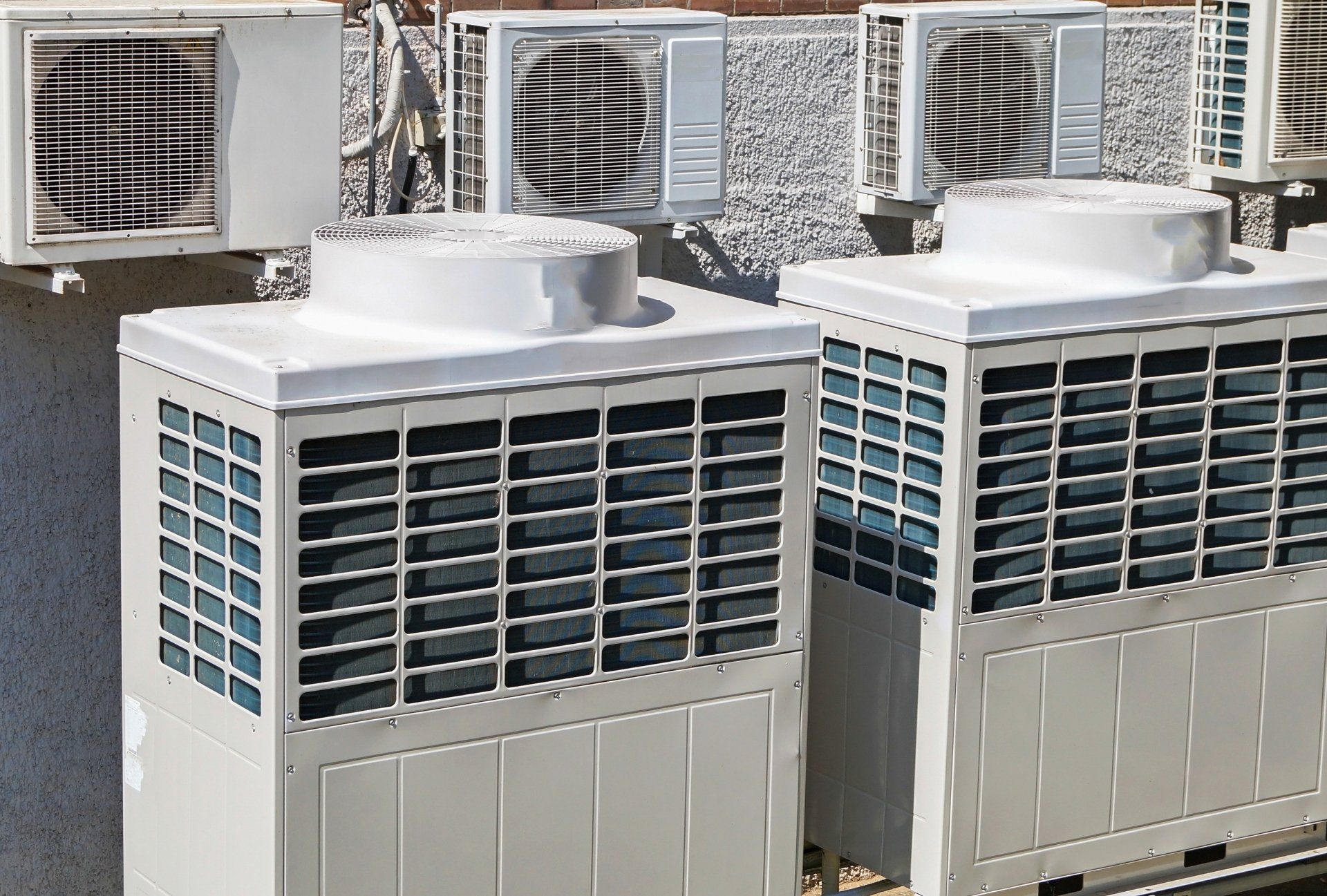 large air conditioners outside next to an office building