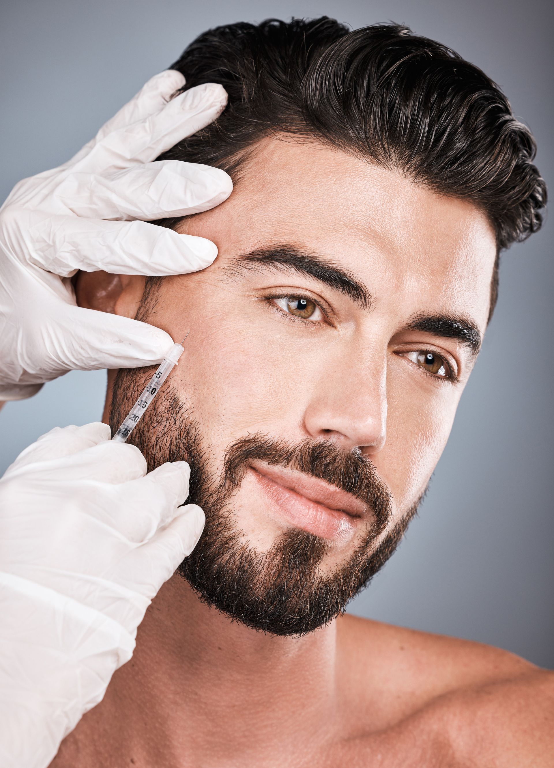 a man with a beard is getting a botox injection