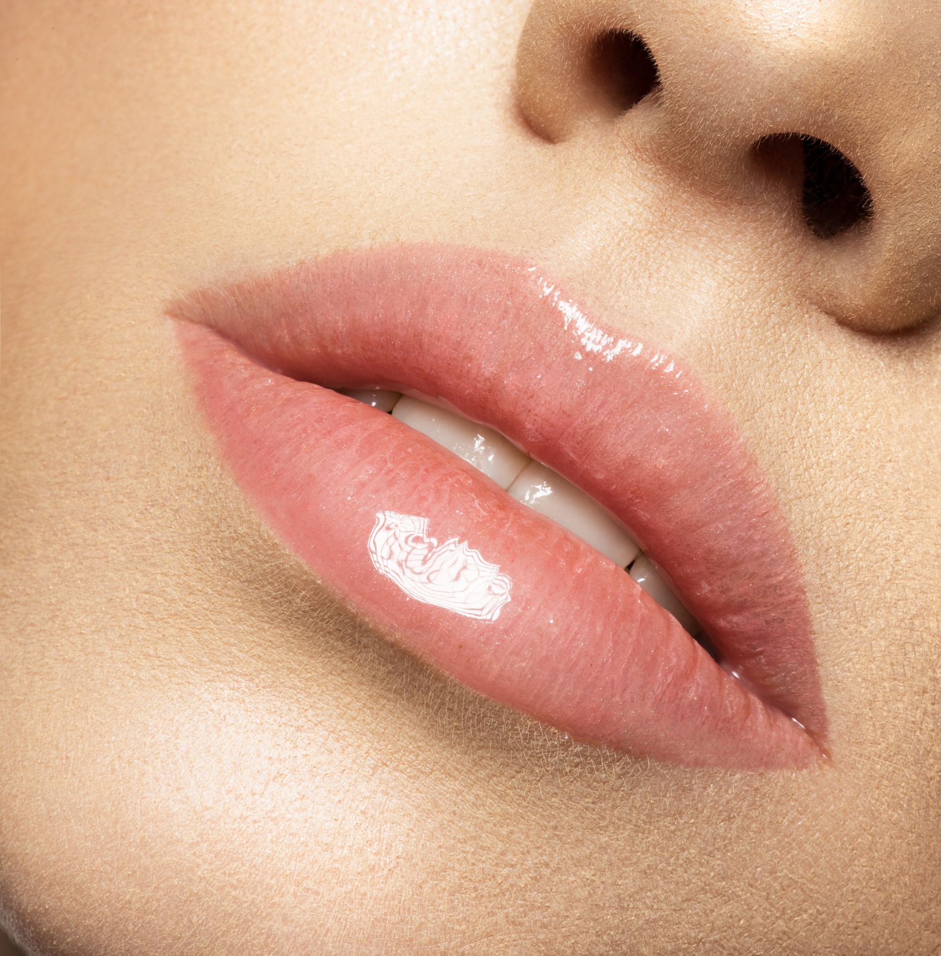 a close up of a woman 's lips with pink lipstick .