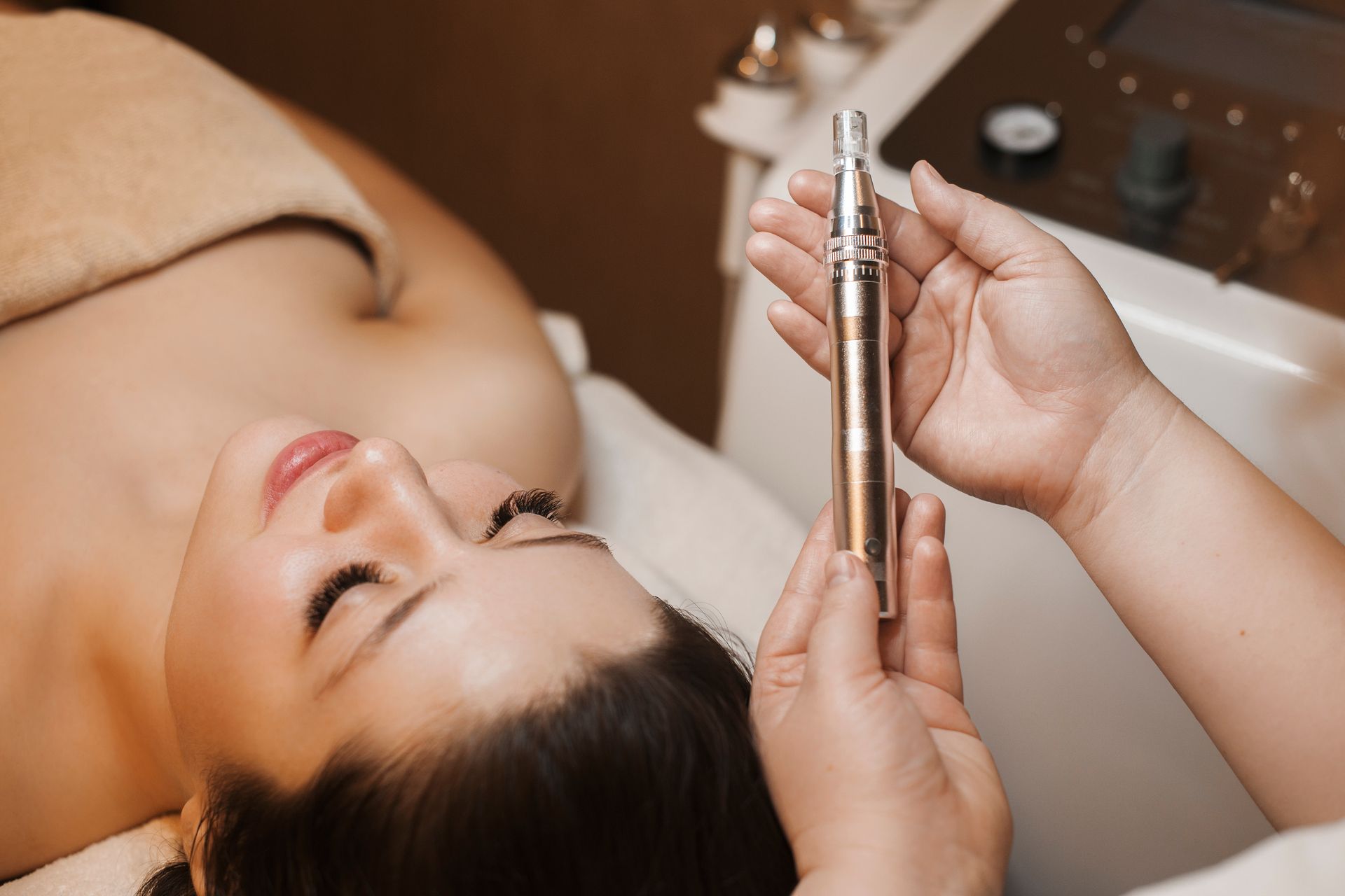 a woman is laying on a bed while a person holds a device that says ' ipl ' on it