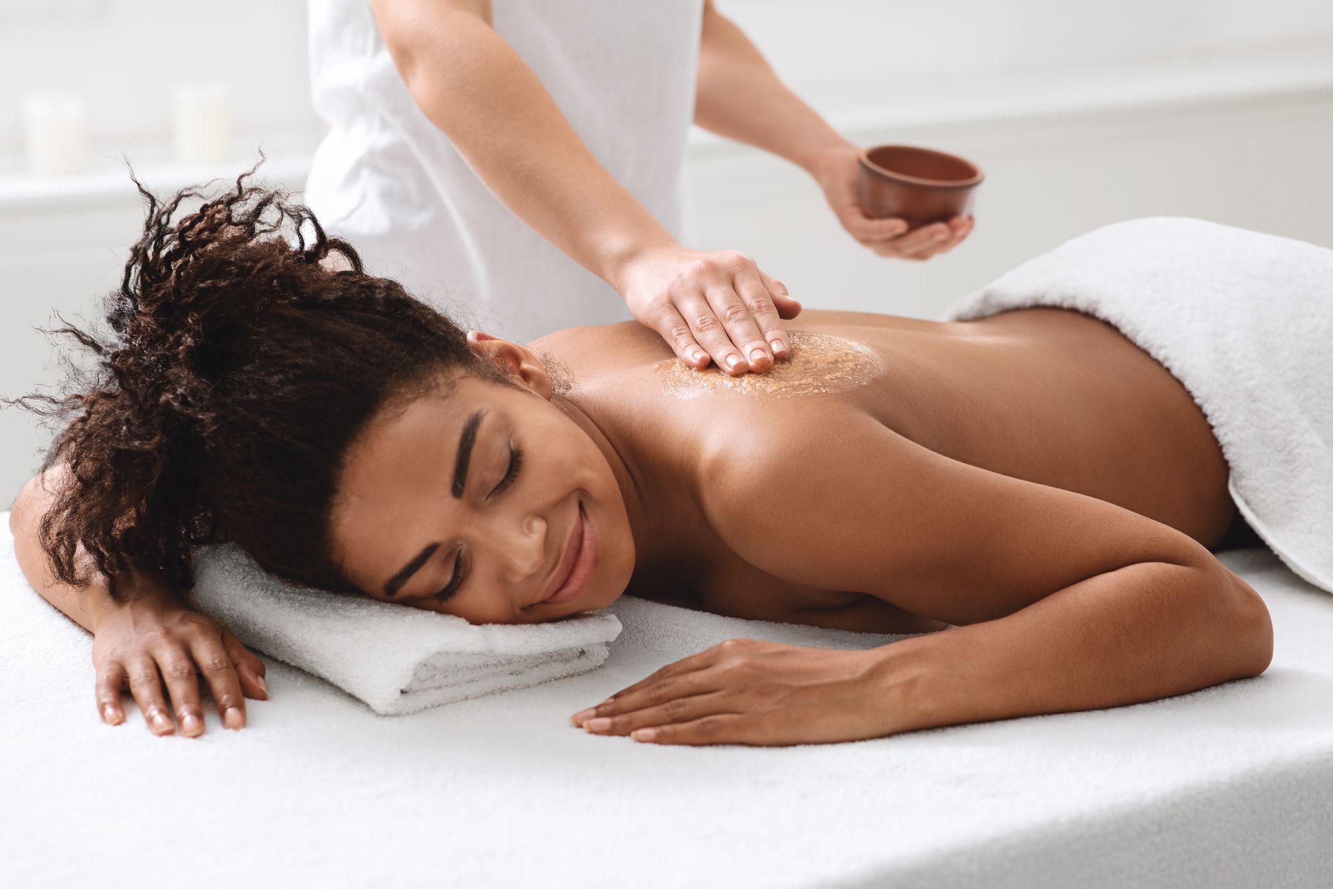 a woman is getting a massage at a spa