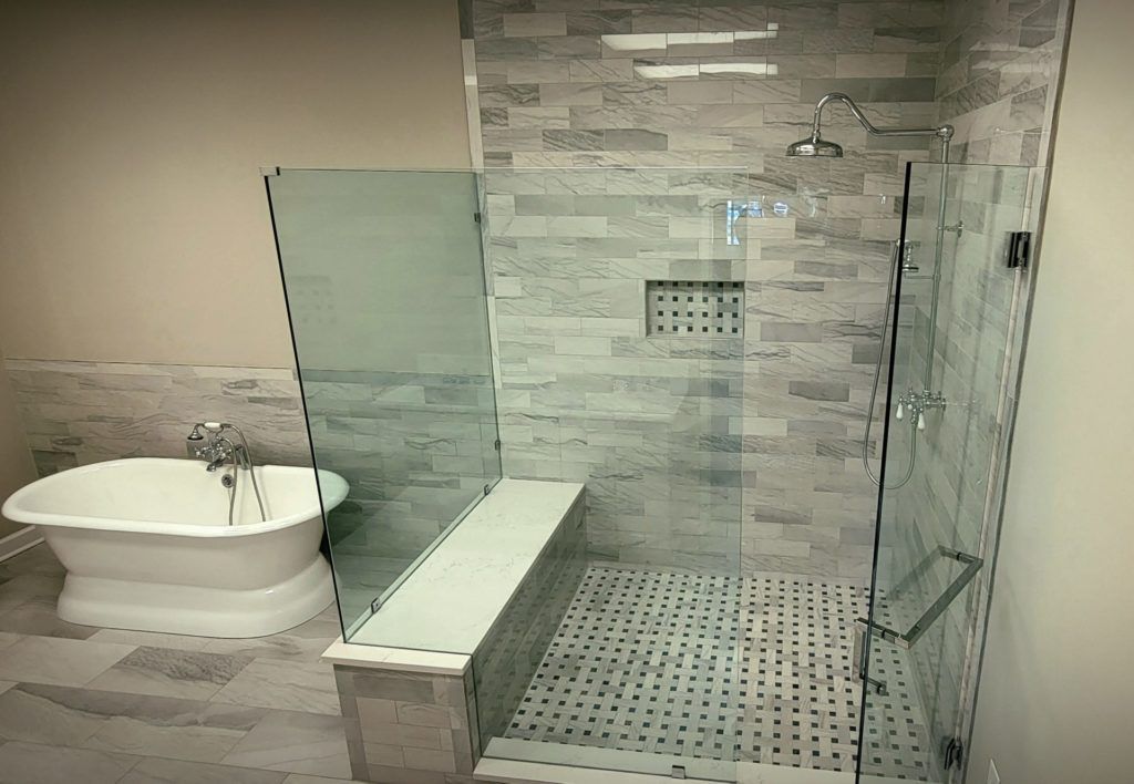 a bathroom with a tub and a walk in shower