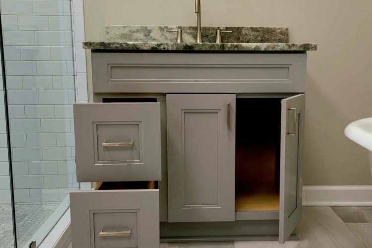a bathroom vanity with drawers open and a sink 