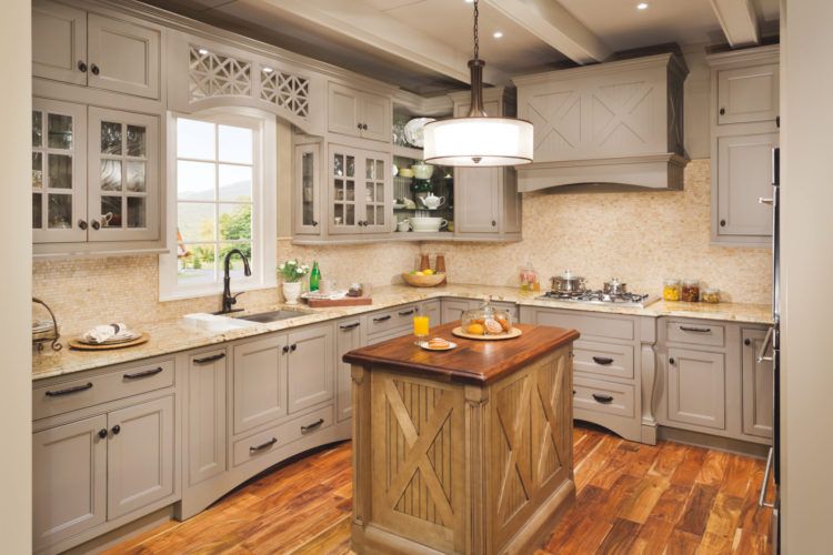 a kitchen with gray cabinets and a wooden island
