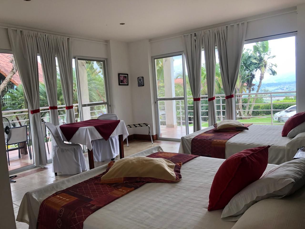 Una habitación de hotel con dos camas, una mesa y sillas.