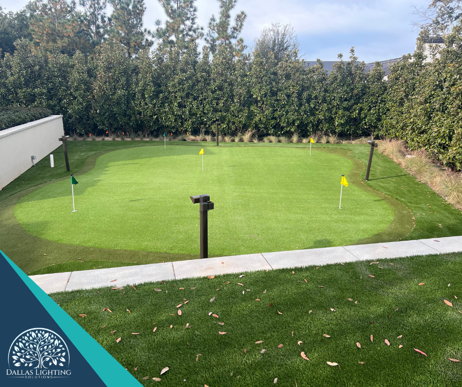 A green golf course with a yellow flag in the middle