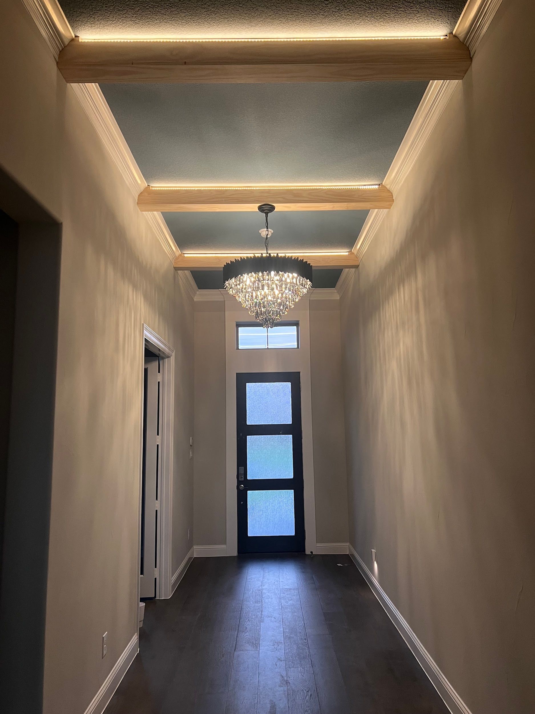 A hallway with a chandelier hanging from the ceiling
