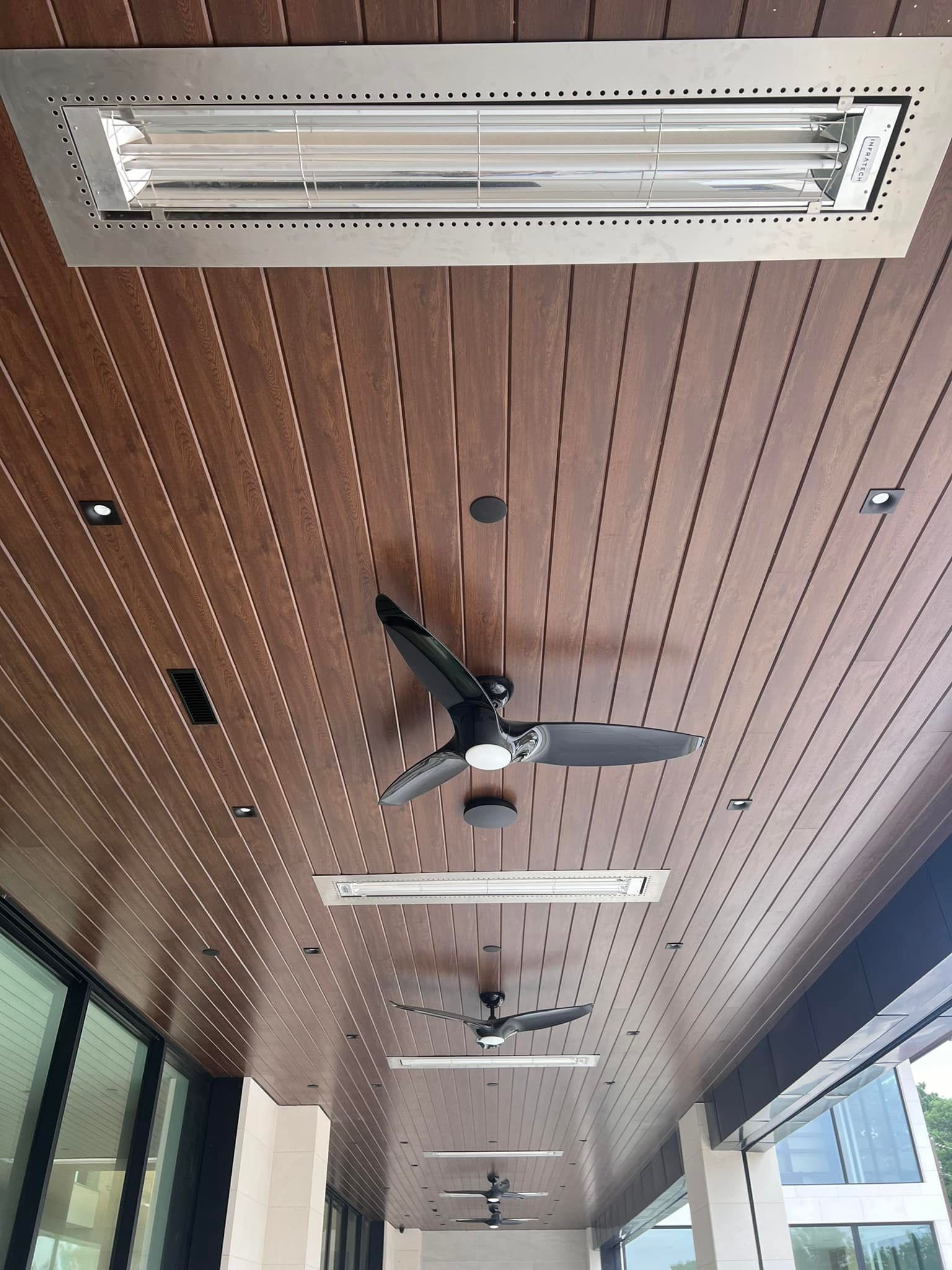Ceiling fans are hanging from the ceiling of a building