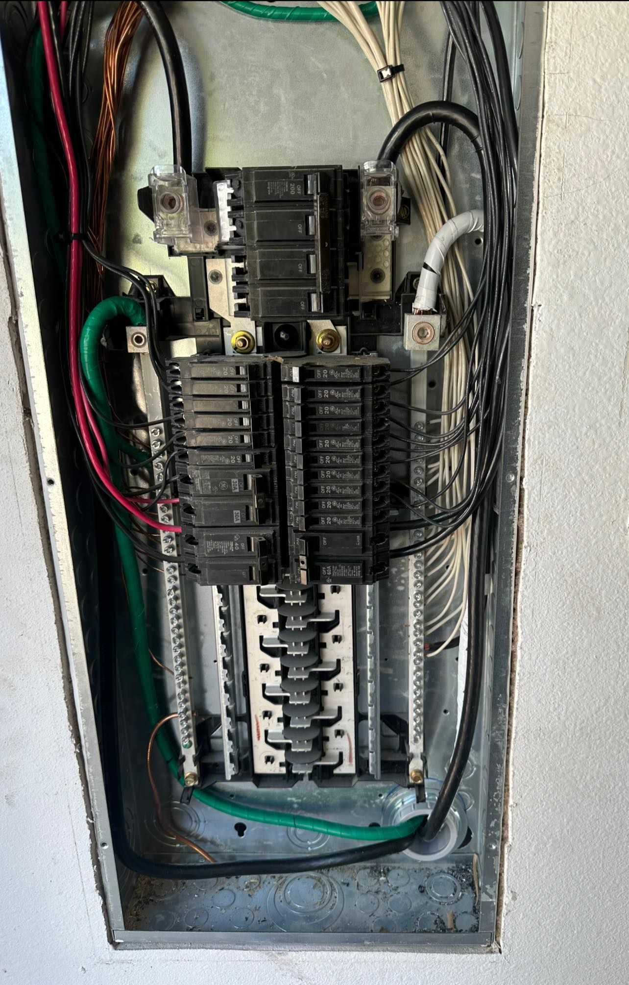 A close up of a electrical box with wires coming out of it.