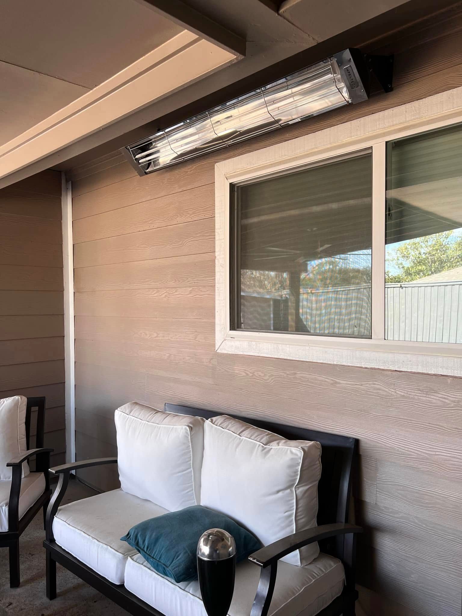 A patio with a couch and chairs and a window.