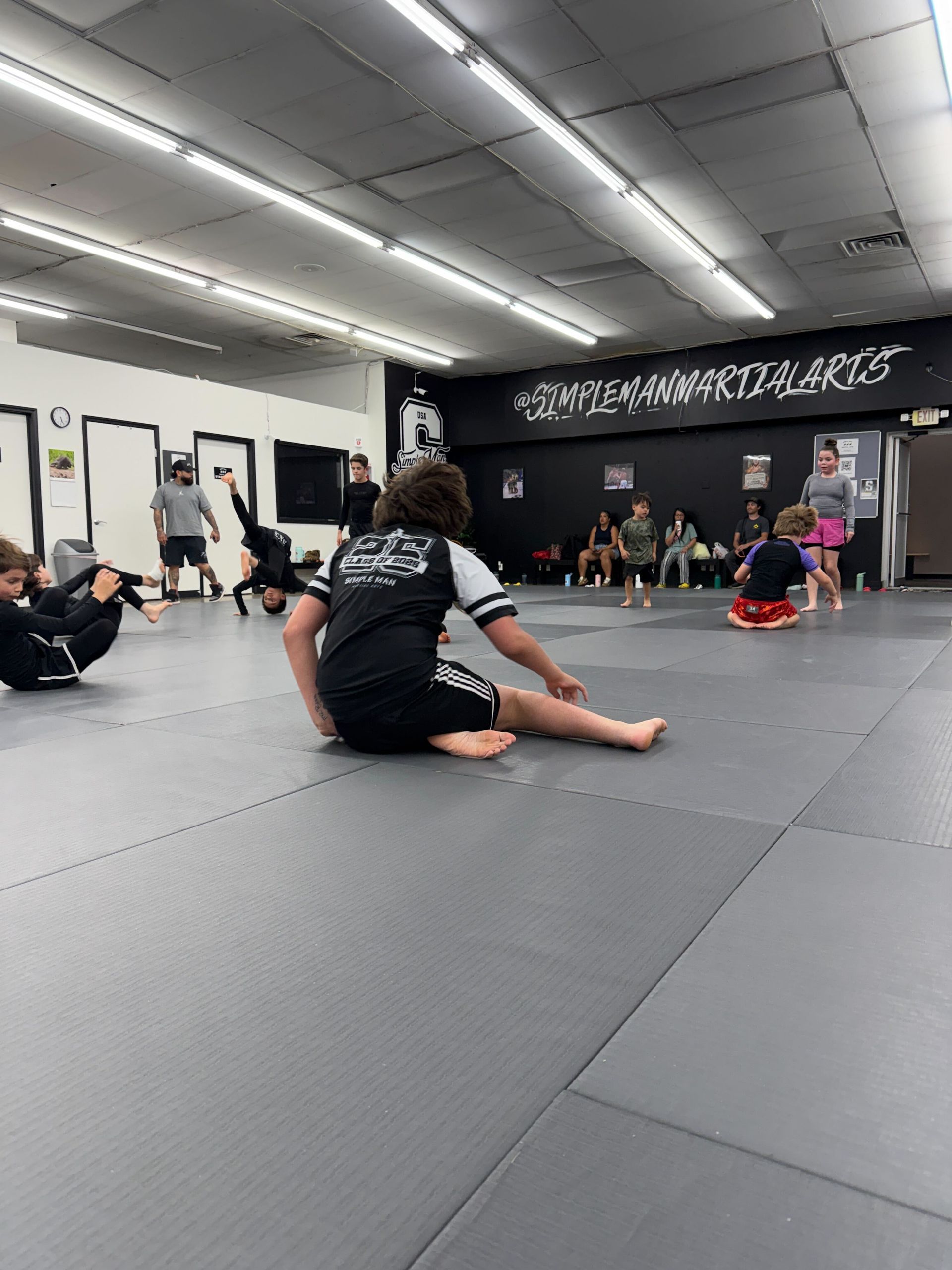 Students drilling Jiu-Jitsu control and escapes at Simple Man Martial Arts in Austin, TX.