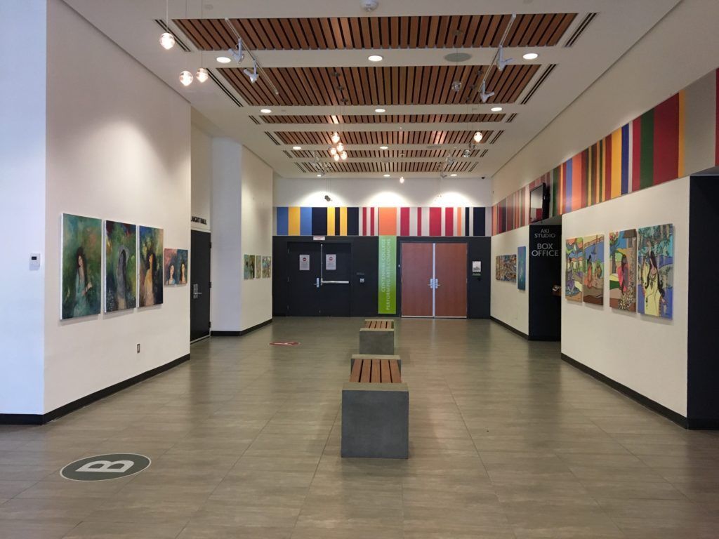 A large room with a lot of paintings on the walls