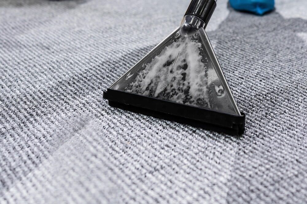 Carpet Cleaner Head Extracting Cleaning Solution From a Gray Carpet — Cleanaroo Services in Conder, ACT