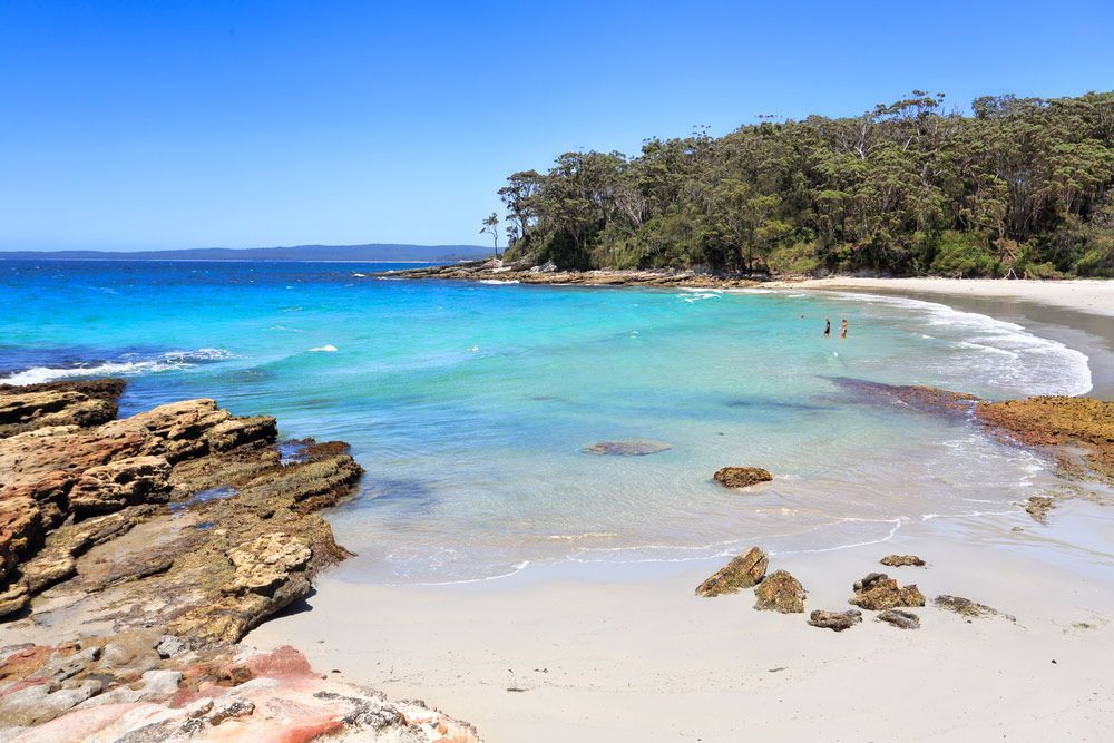 A Beach With A Lot Of Rocks And Trees In The Background — Topflite Roofing In Jervis Bay, NSW
