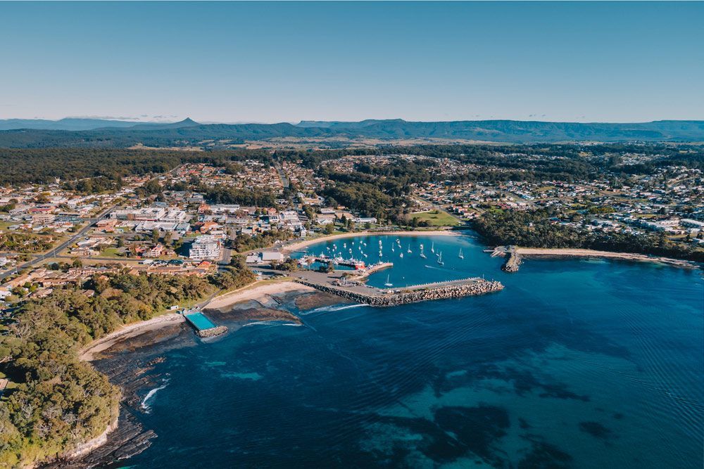 An Aerial View Of A Harbor With A City — Topflite Roofing In Ulladulla, NSW
